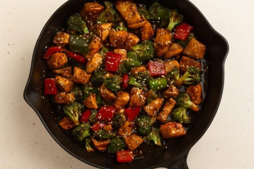 Cooked chicken added back to pan with sauce and veggies, stirred together and ready to serve.