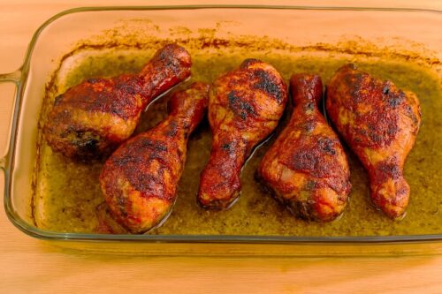 Garlic-Herb-Roasted-Chicken-4 Golden brown roasted chicken with crispy edges being basted with pan juices for added shine and flavor in garlic herb chicken recipe.
