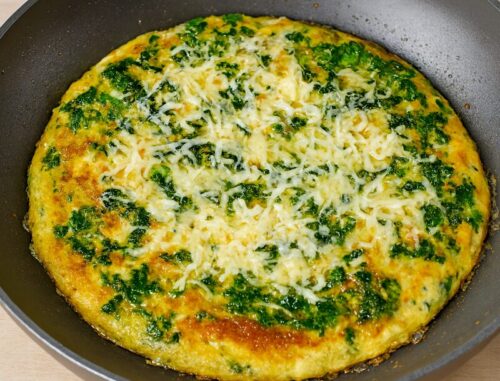 Quesadilla-4 Crispy tortilla flipped over cooked spinach omelette in pan, sealing cheese filling for savory breakfast quesadilla.
