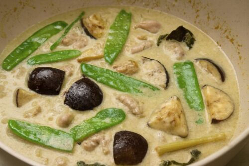 Fish sauce and sugar mixed into curry for sweet-salty balance, with snow peas, bamboo shoots, and kaffir lime leaves added