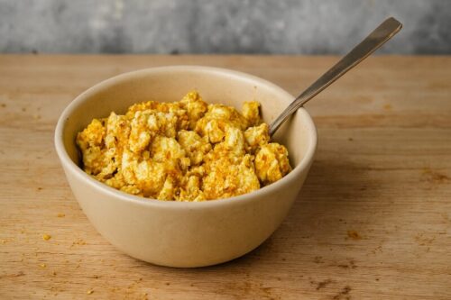 Veggie-Breakfast-Burrito-Bowl-1 Crumbled tofu mixed with garlic powder, onion powder, turmeric, and soy sauce for vegan breakfast bowl