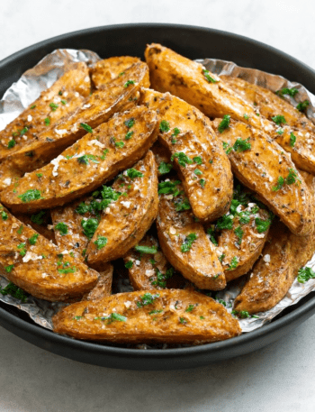 Hot potato wedges tossed with Parmesan cheese and parsley